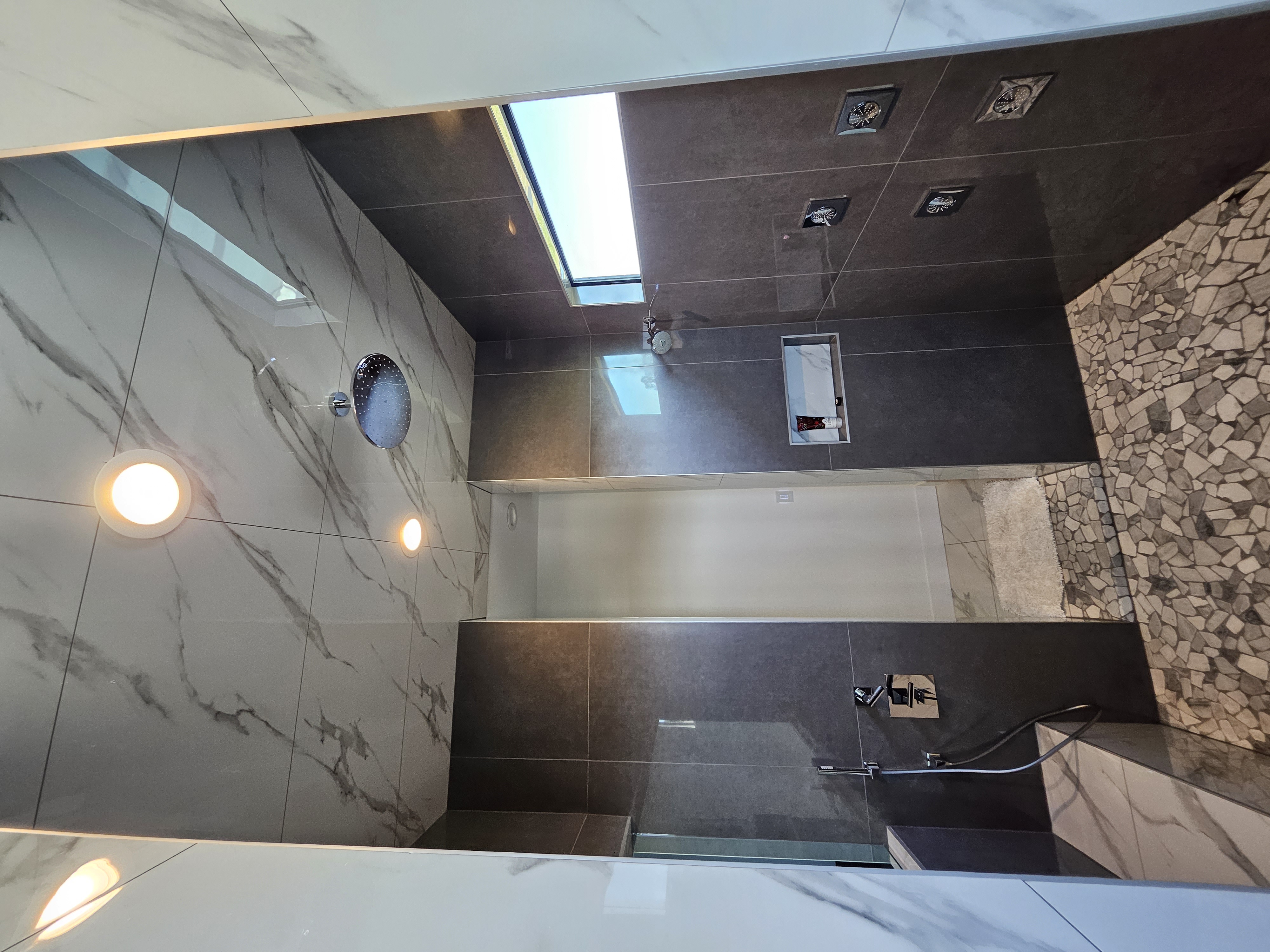 Spa-style master walk-in shower with rain head and bench seat